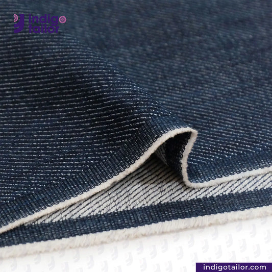 Close-up of WILD INDIGO denim fabric with a visible brand logo in the corner.
