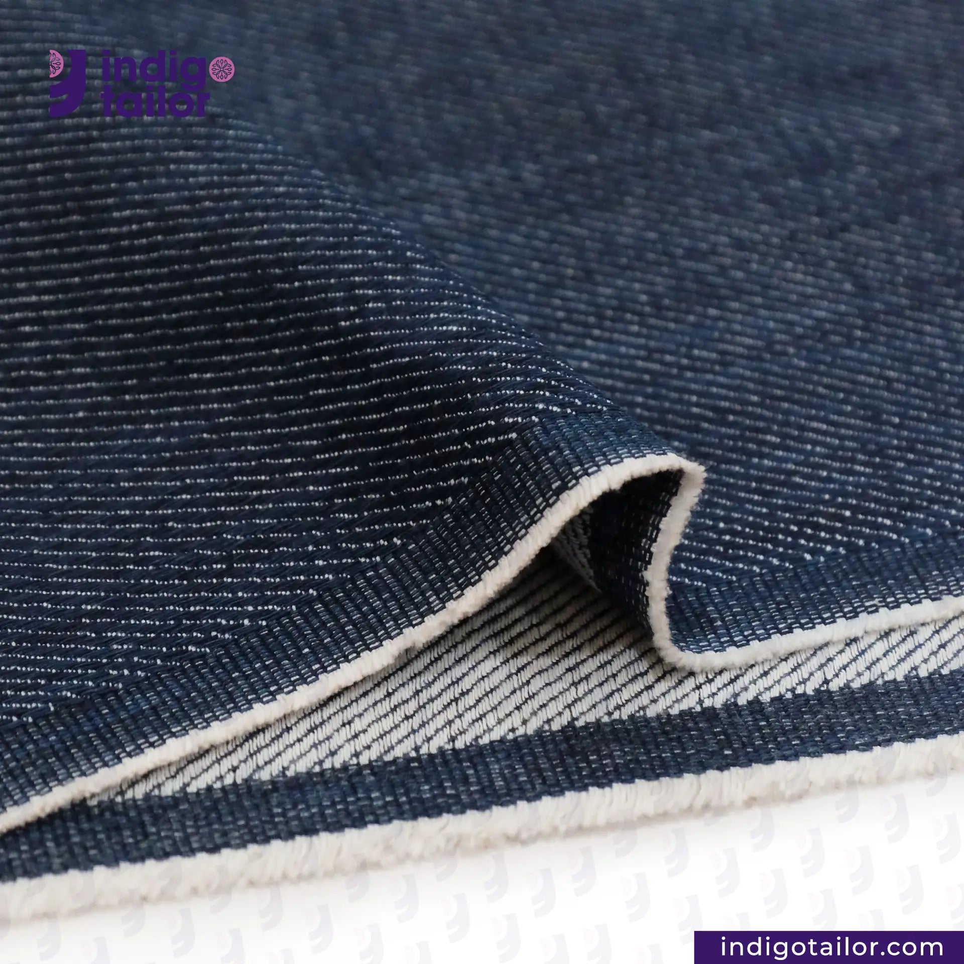 Close-up of WILD INDIGO denim fabric with a visible brand logo in the corner.